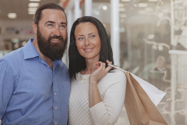 Happy mature couple shopping at the mall