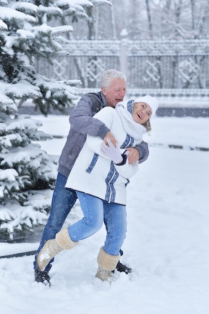 Happy mature couple smiling and posing, have fun outdoors