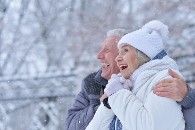 Happy mature couple smiling and posing, have fun outdoors