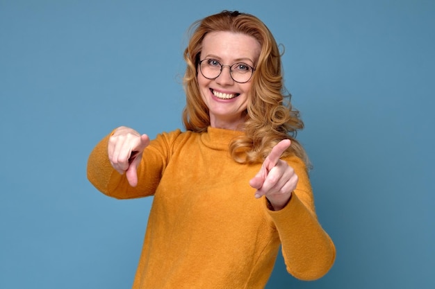 Happy mature woman in glasses pointing at you I choose you