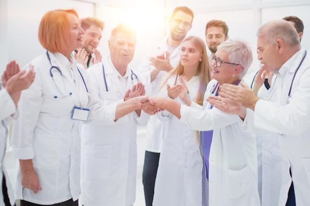 Happy medical colleagues congratulating each other on their success