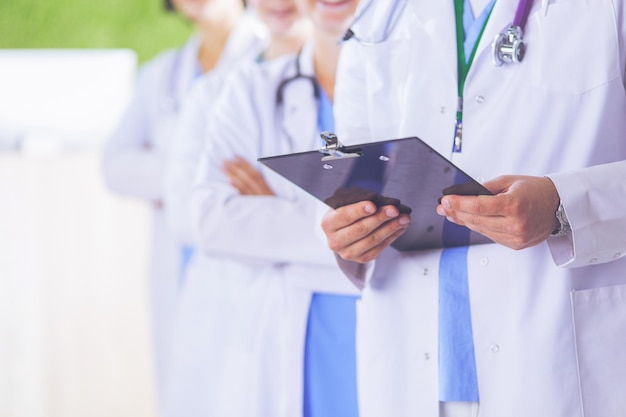 Happy medical team comprising male and female doctors smiling broadly and giving a thumbs up of succ