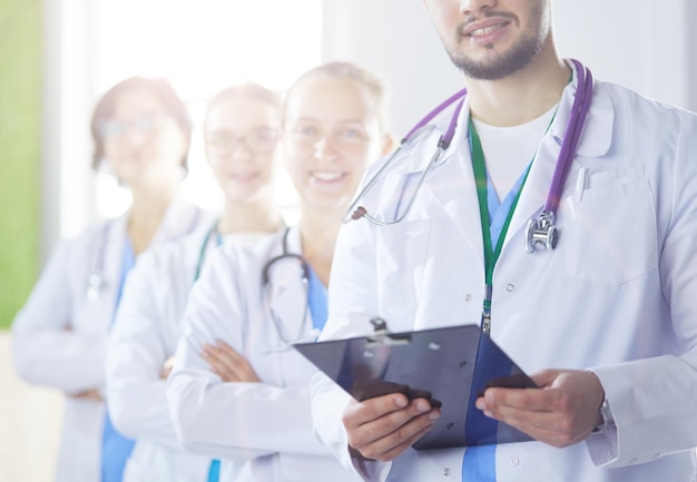 Happy medical team comprising male and female doctors smiling broadly and giving a thumbs up of succ