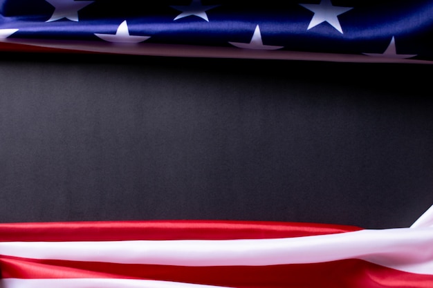 Happy Memorial Day or Independence Day.  American flags against a black paper background.