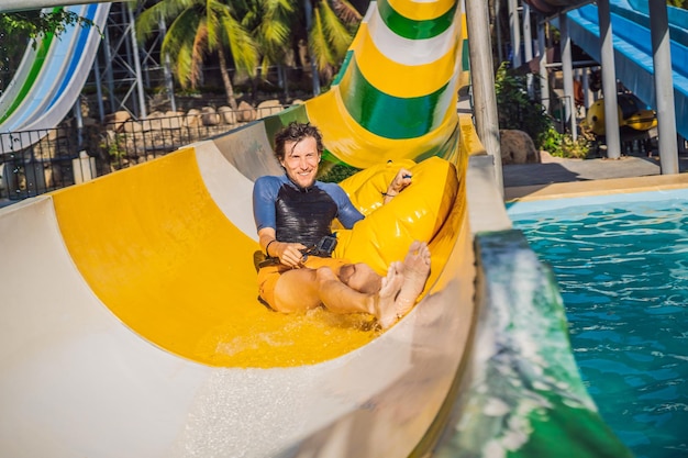 Happy men have fun on aqua park