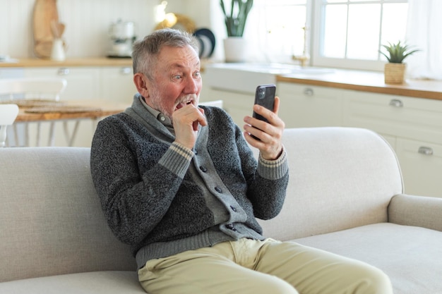 Happy middle aged senior man talk on video call with friends family laughing mature old senior grand