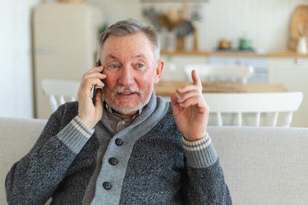 Happy middle aged senior man talking on smartphone with family friends older mature grandfather with