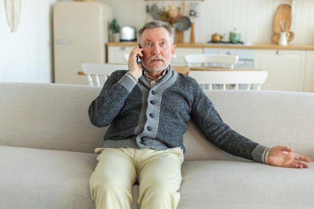 Happy middle aged senior man talking on smartphone with family friends older mature grandfather with