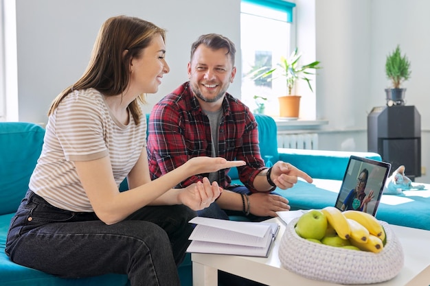 Happy middleaged couple at an online meeting with doctor