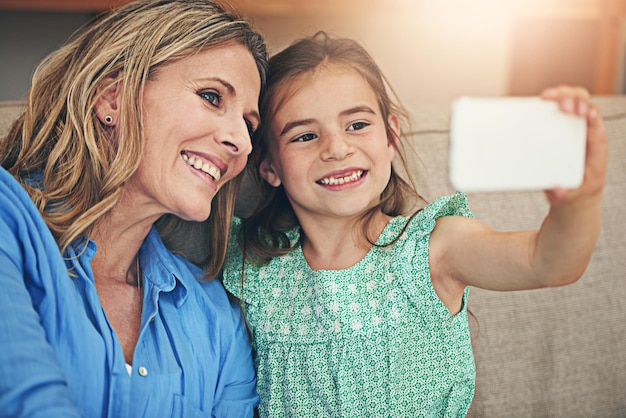 Photo happy mom daughter and relax with selfie on sofa for picture memory or bonding together at home mother child or kid with smile for photography capture or moment on living room couch at house