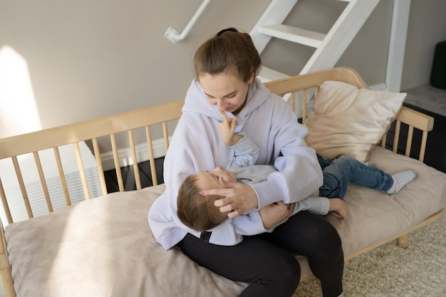 Happy mom and son hug, spend time at home together.