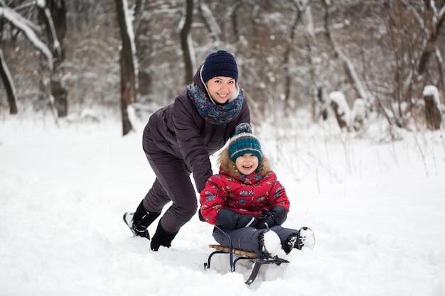 Happy mother and baby in winter park