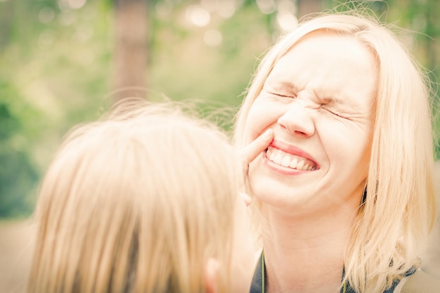 Happy mother A blond woman laughs Toned