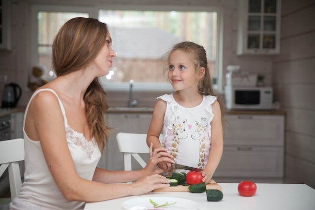 Happy mother and daughter cooking together