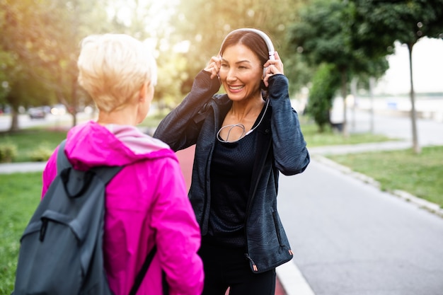 Happy mother and daughter enjoying in walk outdoors in park.