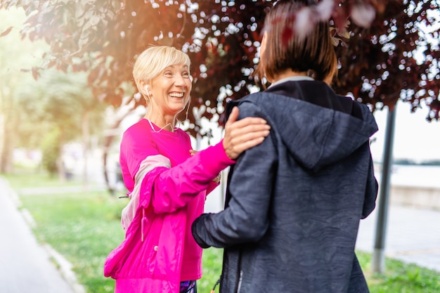 Happy mother and daughter enjoying in walk outdoors in park.