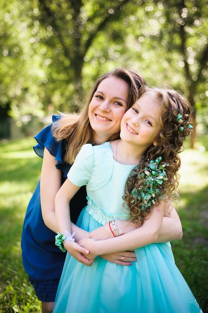 Happy mother and daughter together outdoors in a park