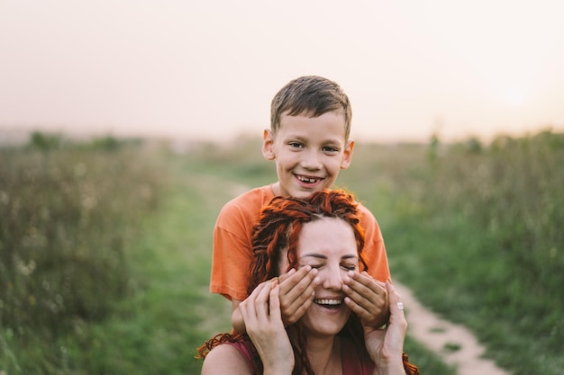 Happy mother having fun with her son outdoor Family and love concept The concept of mother's day relationships with adolescents care and love