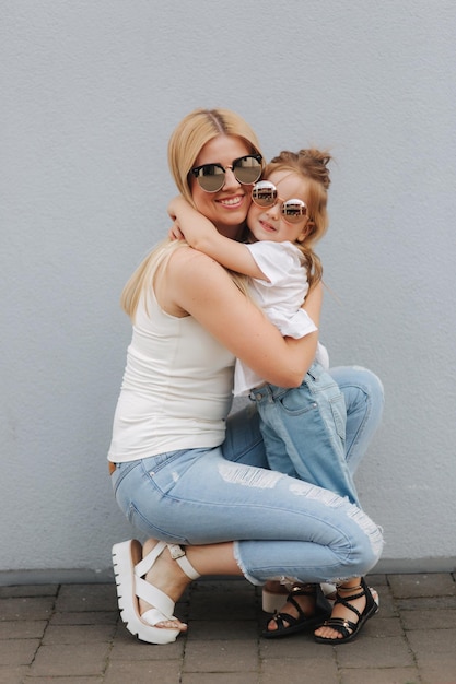 Happy mother and her little daughter in the summer day