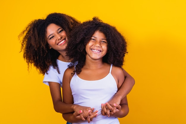 Happy mother's day! Adorable sweet young afro-american mother with cute little daugh.