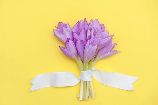 Happy mother's day. Beautiful bouquet of flowers on a yellow background, flat lay