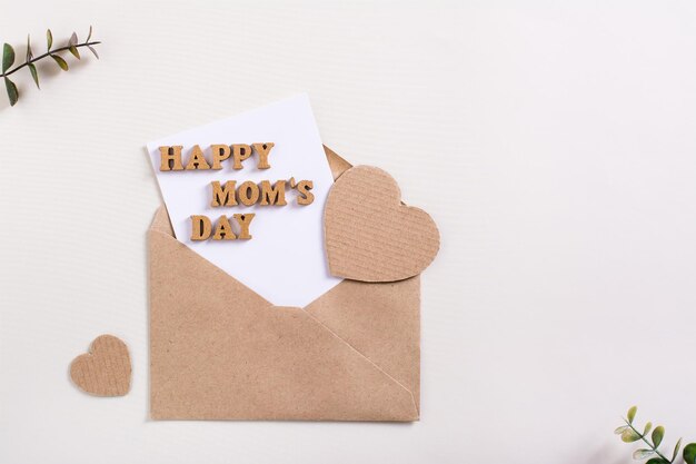 Happy mother's day Envelope with a sheet letters and hearts on a light background