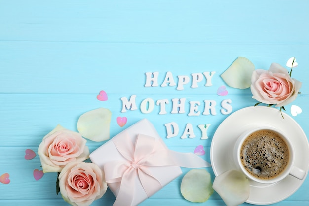 Happy Mother's Day text with roses, hearts and gifts on blue background