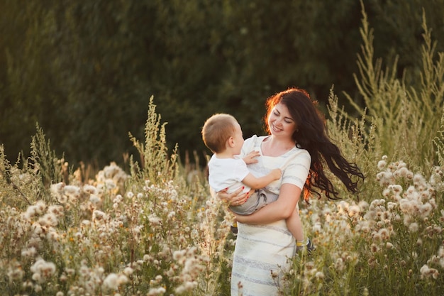 Happy mother and son playing in the field