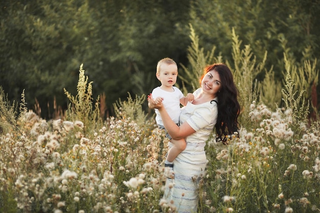 Happy mother and son playing in the field