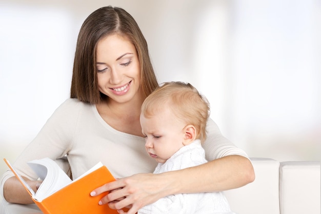 Happy mother with  sweet baby boy and book