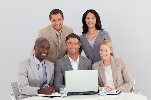 Happy multi-ethnic business team working in office together