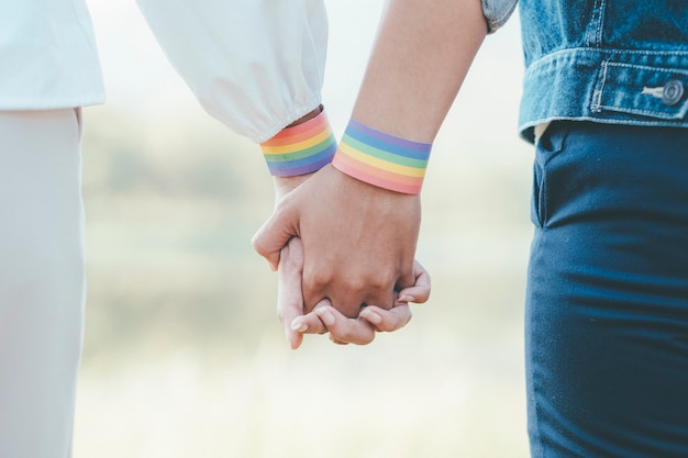 Happy multiracial girlfriends in love embracing and cuddling - Lesbian couple, millennials women, girls in London living happy lifestyle - LGBTQ concept with mixed race beautiful couple