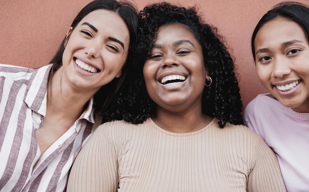 Happy multiracial girls smiling on camera