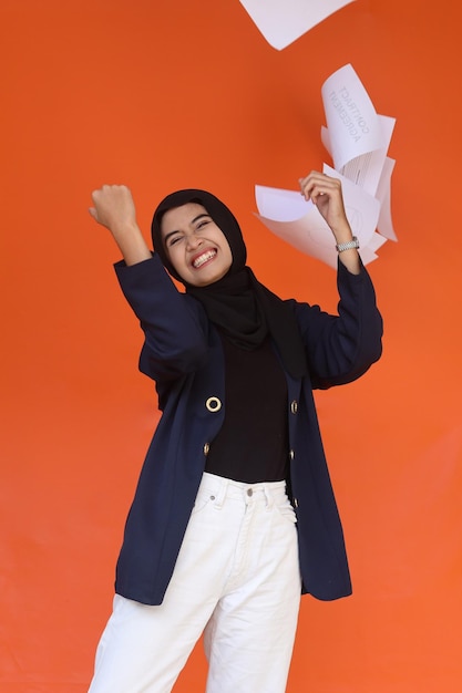 Happy muslim business woman throwing up papers documents. Achievement career wealth business concept