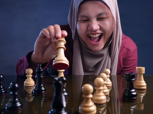 Happy Muslim Woman Playing Chess