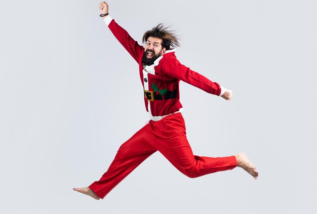 Happy new 2021 year. merry christmas. xmas party fun. happy bearded man hipster wear red festive elf costume. mature santa claus jumping. funny winter holiday celebration. feel free.