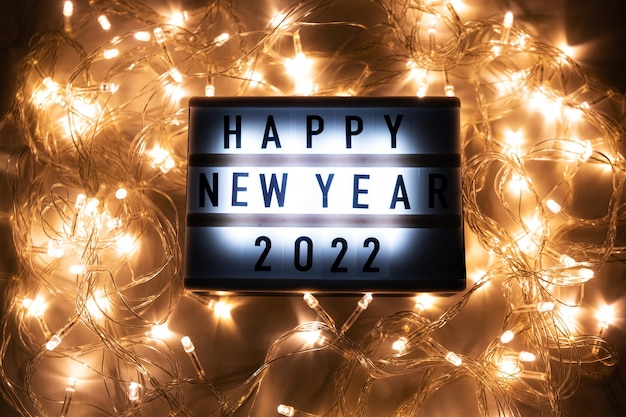 Happy New Year 2022. Christmas lights with the inscription