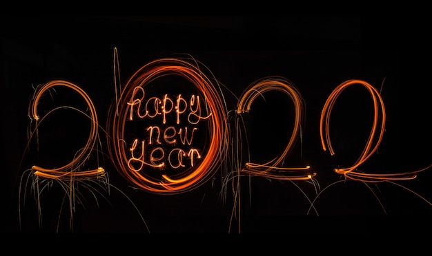 Happy New Year 2022 Sparkling burning text Happy New Year 2022 isolated on black background