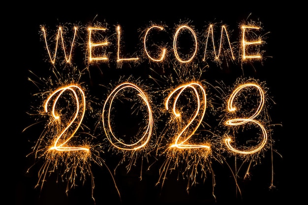 Happy New Year 2023. Sparkling burning text Happy New Year 2023 isolated on black background. Beauti