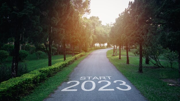 Happy new year 20232023 symbolizes the start of the new year The letter start new year 2023 on the road in the nature garden park have tree environment ecology or greenery wallpaper concept