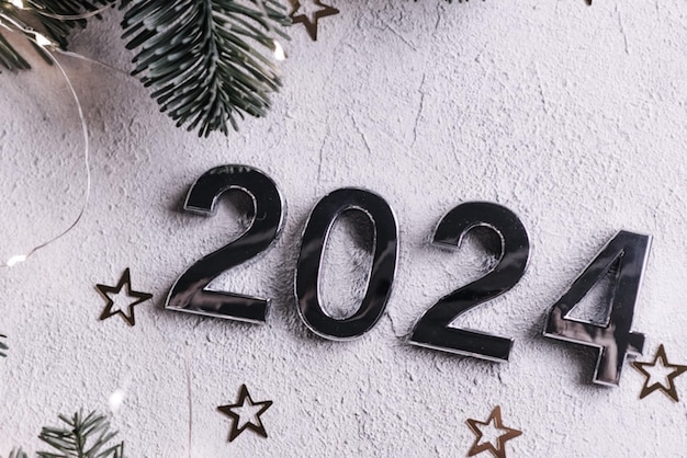 Happy New Year 2024 greeting card Beautiful holiday web banner or poster with the golden shiny text Happy New Year 2024 sparkling writings on a festive blue background with fireworks