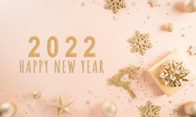 Happy New year celebration background concept. Golden gift box, stars, christmas ball and champagne on pastel background.