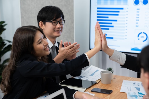 Happy office worker making high five with each other in harmony workplace