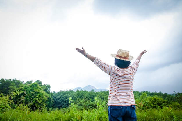 Happy old women travel in the mountains during the rainy season.