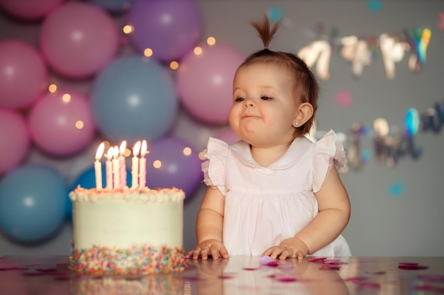 Happy one year old child with a birthday cake Childs birthday