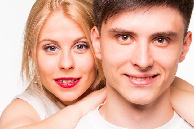 Happy pair of male and female embracing isolated on white background