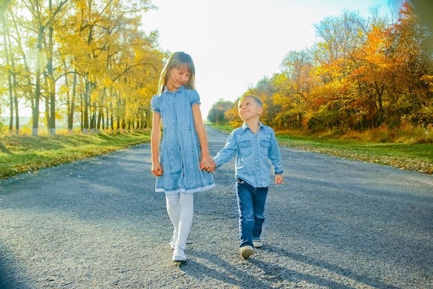 A Happy parent with child are walking along the road in the park on nature travel