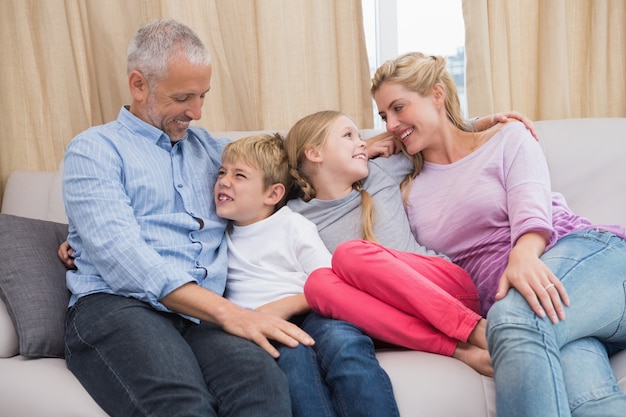 Happy parents with their children on sofa