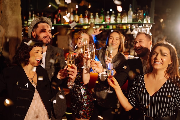 Happy people celebrating winter holiday together with champagne Party celebration concept