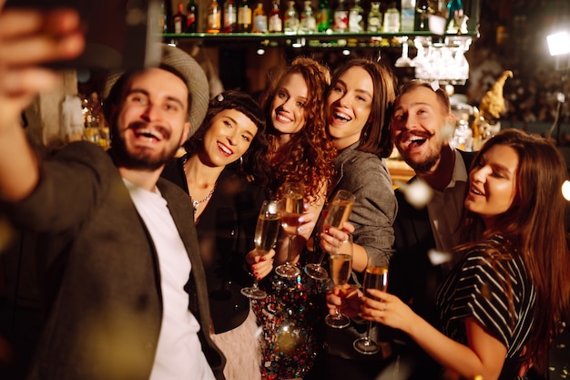 Happy people celebrating winter holiday together with champagne Party celebration concept